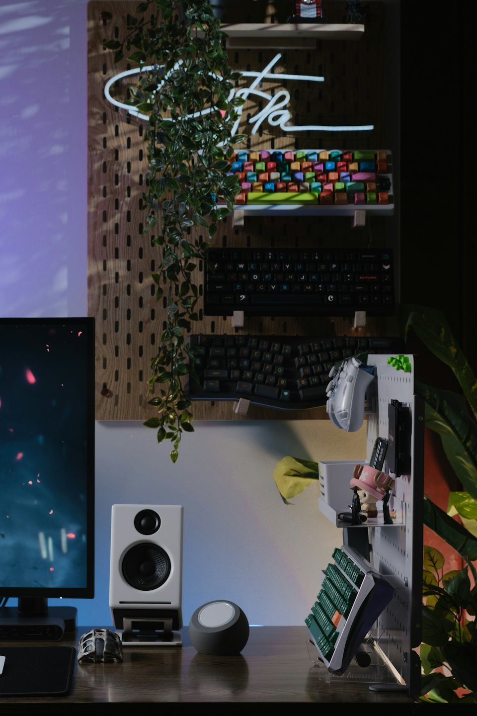 Modern desk setup featuring mechanical keyboards and a monitor display.